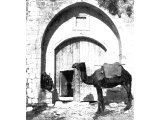 `Eye of a Needle` in the gate of a khan at Nazareth. The entrance to caravanserais in Palestine had a small door known as `the eye` for foot passengers. The huge doors are opened only for pack-animals or wheeled vehicles.